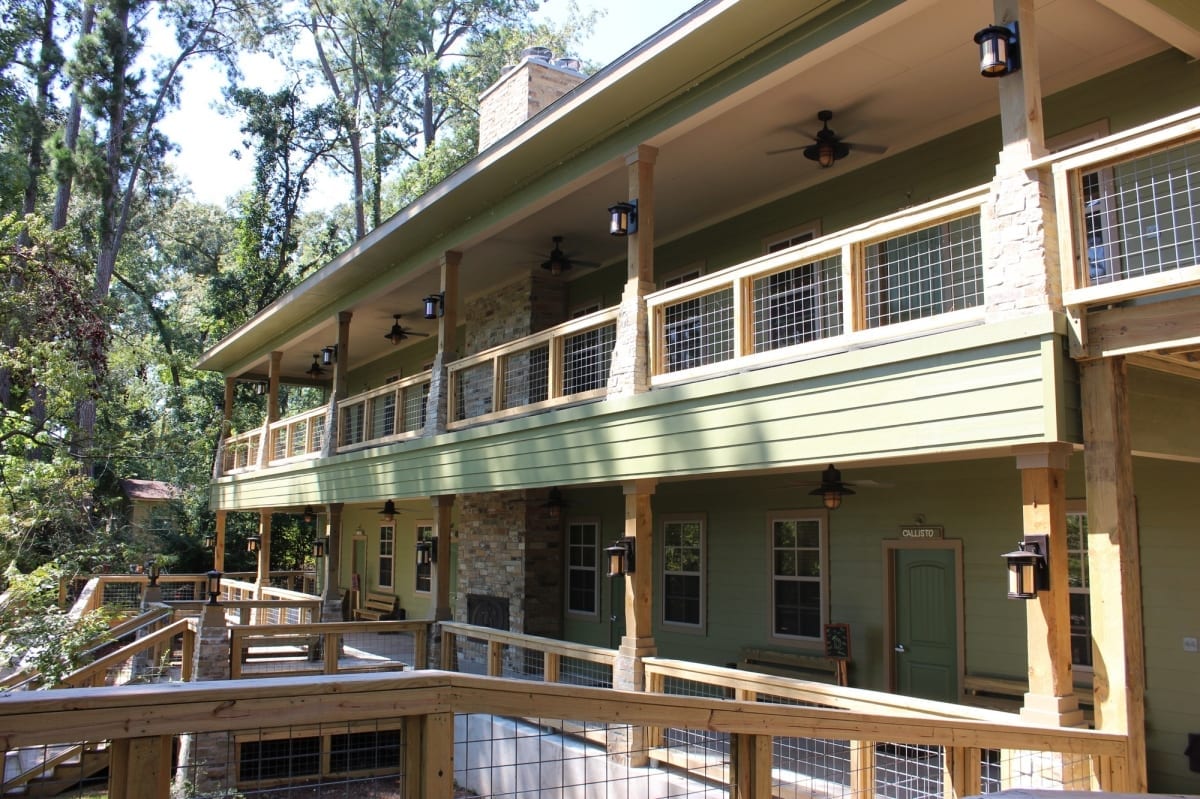 Exterior view of Camp Olympia two-story cabins and walkway.