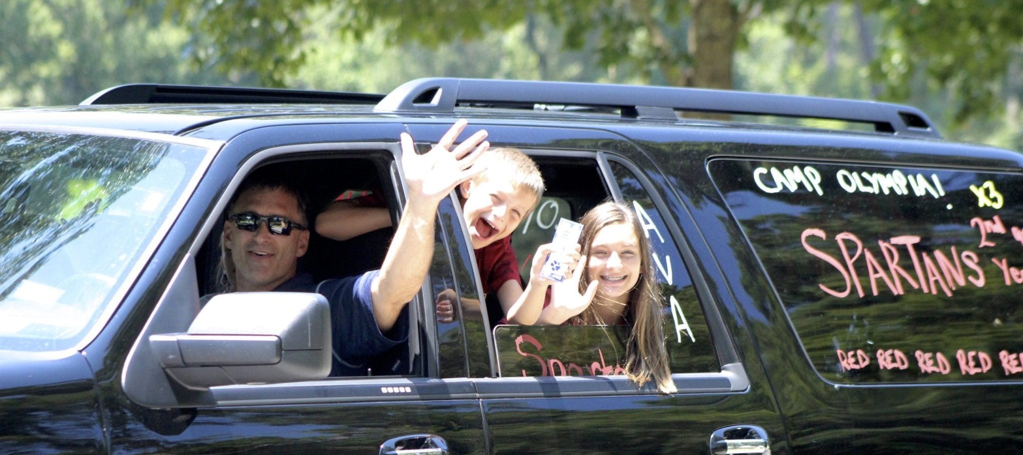 opening day of summer camp with parent and boy camper and girl camper