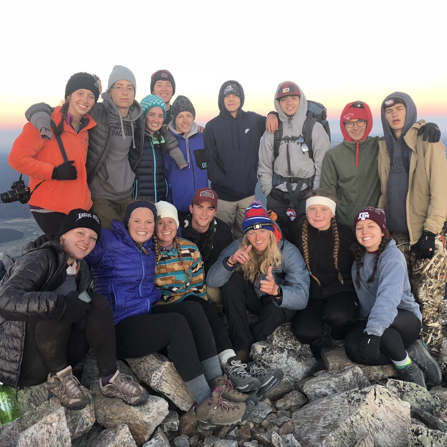 Campers posing for an outdoor group photo during a trip to Colorado.