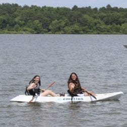 Two female campers kayaking on Lake Livingston.