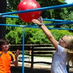 Two young campers playing an o-sport with a rubber ball.