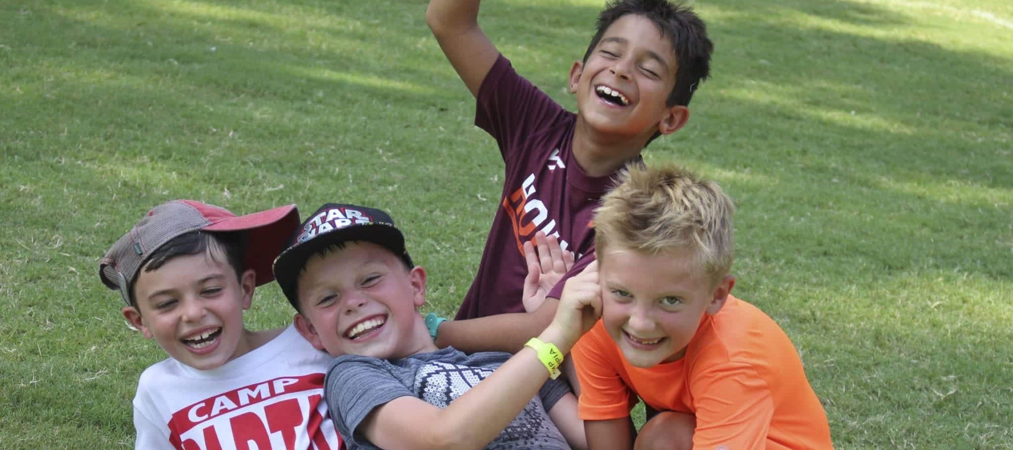 4 boys having fun outdoors at camp olympia