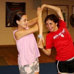 Two smiling female campers participating in a Dance Class.