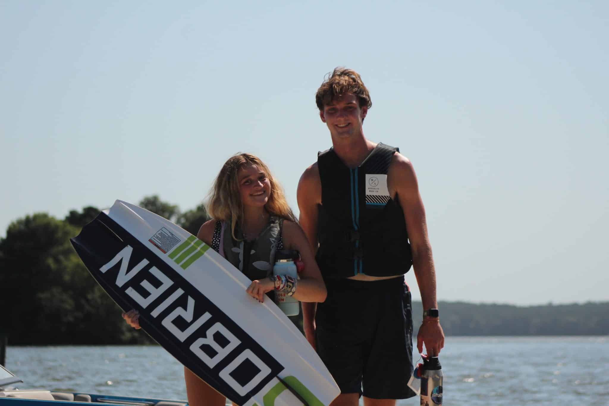 male and female counselor with wakeboard at camp olympia on lake livingston