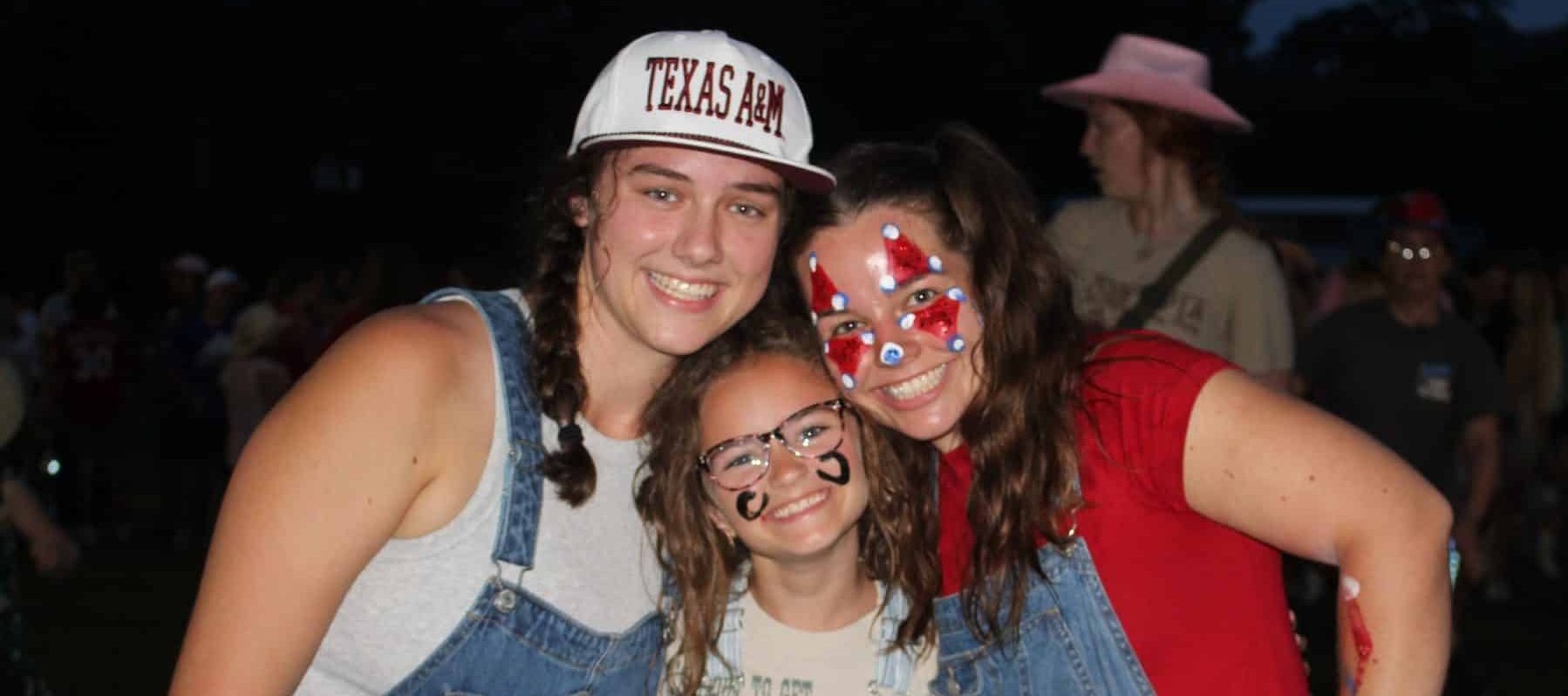 counselors and girl camper at rodeo with face paint