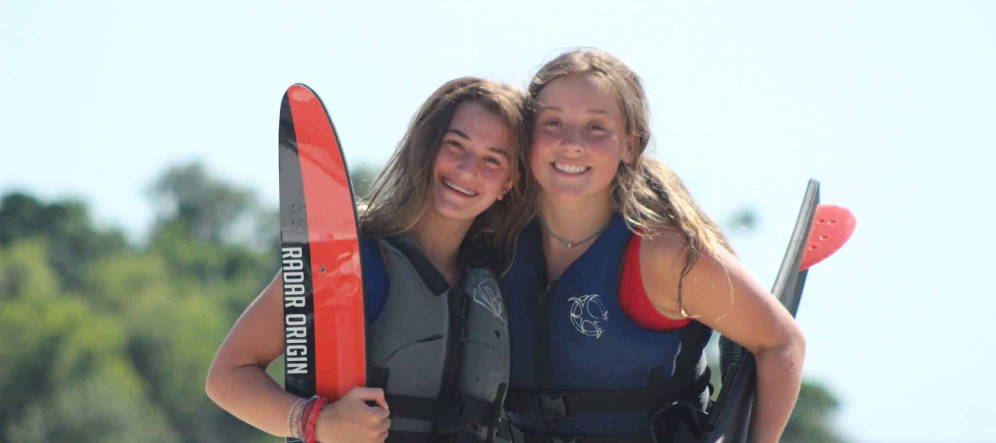 two girl campers with waterski at camp on lake livingston
