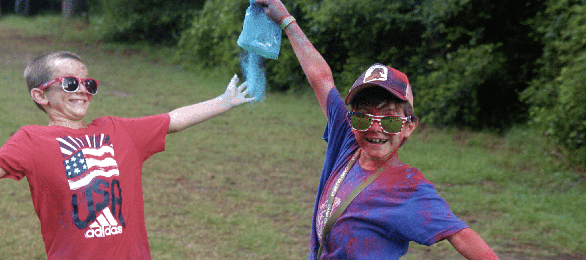 two boys having fun with color chalk for the fourth of july summer camp celebration